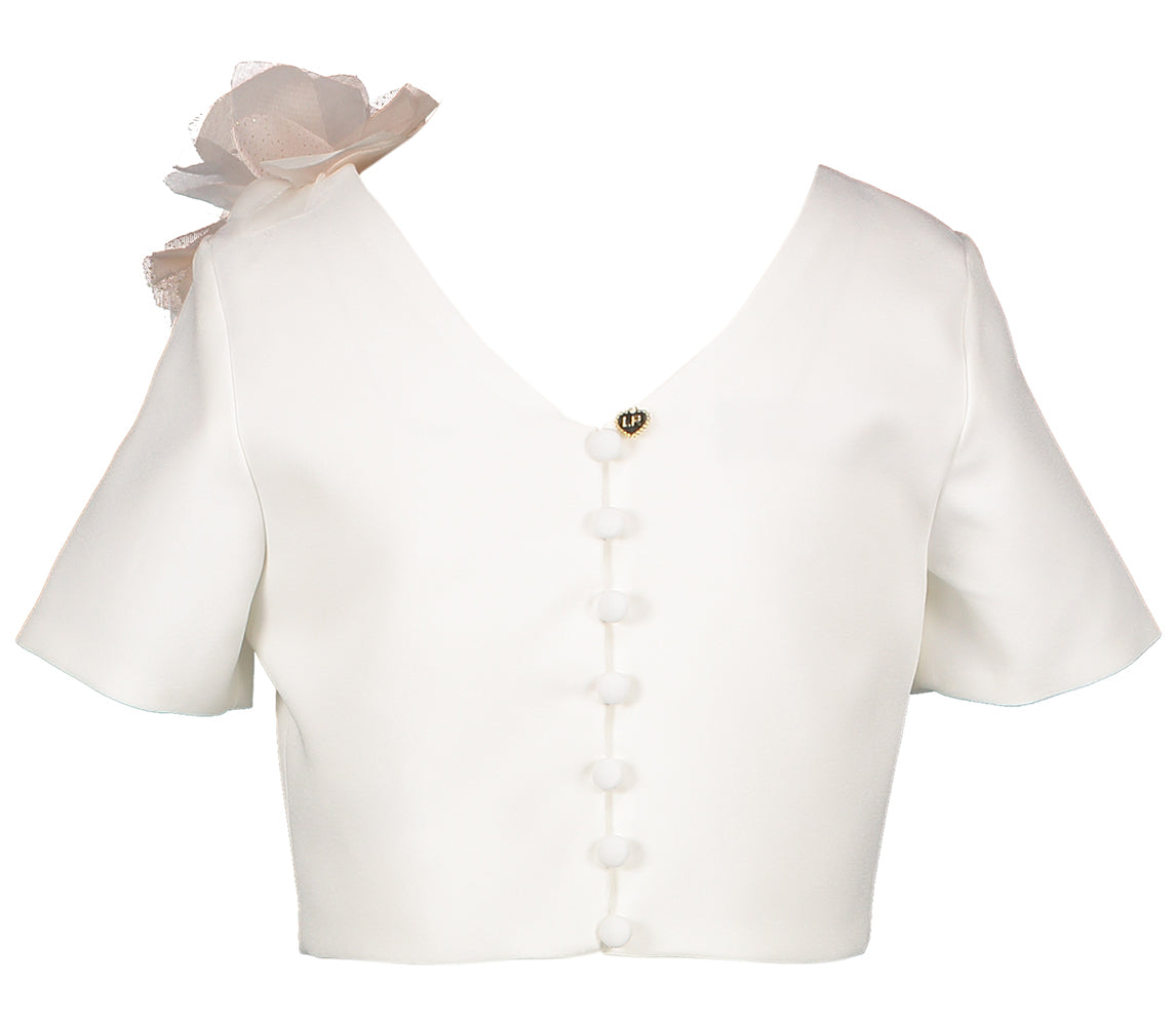 Witte bloes met roze bloem en knoopdetail achteraan Linea Raffaelli