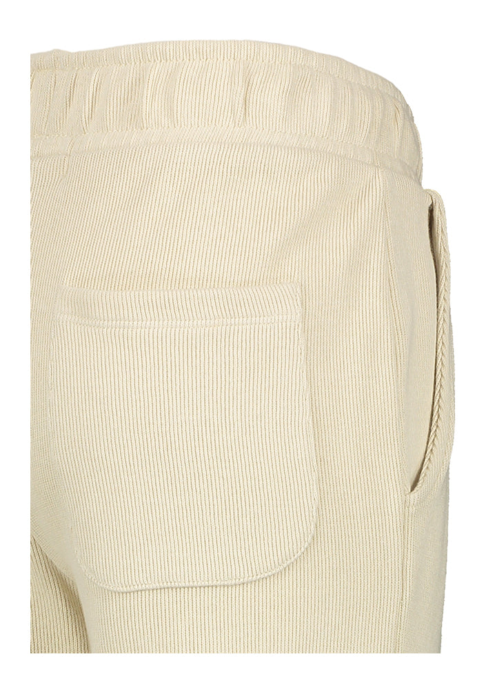 Pantalon-pull couleur sable en tissu côtelé. Nom