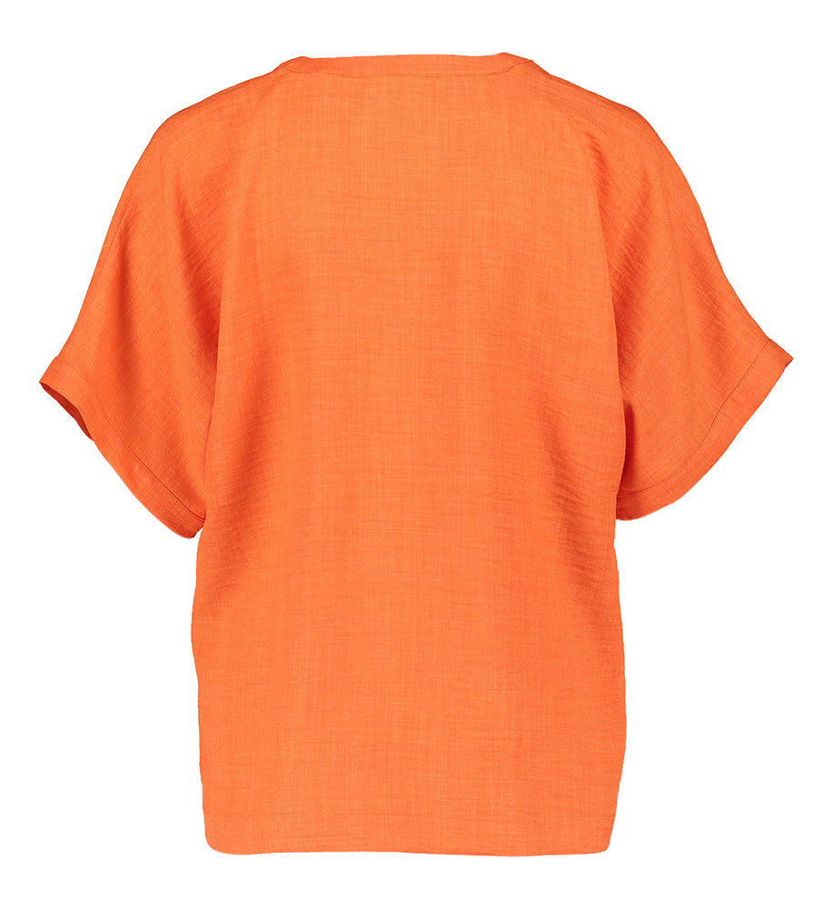 Chemisier rouge orangé à col montant et décolleté en V ELLE