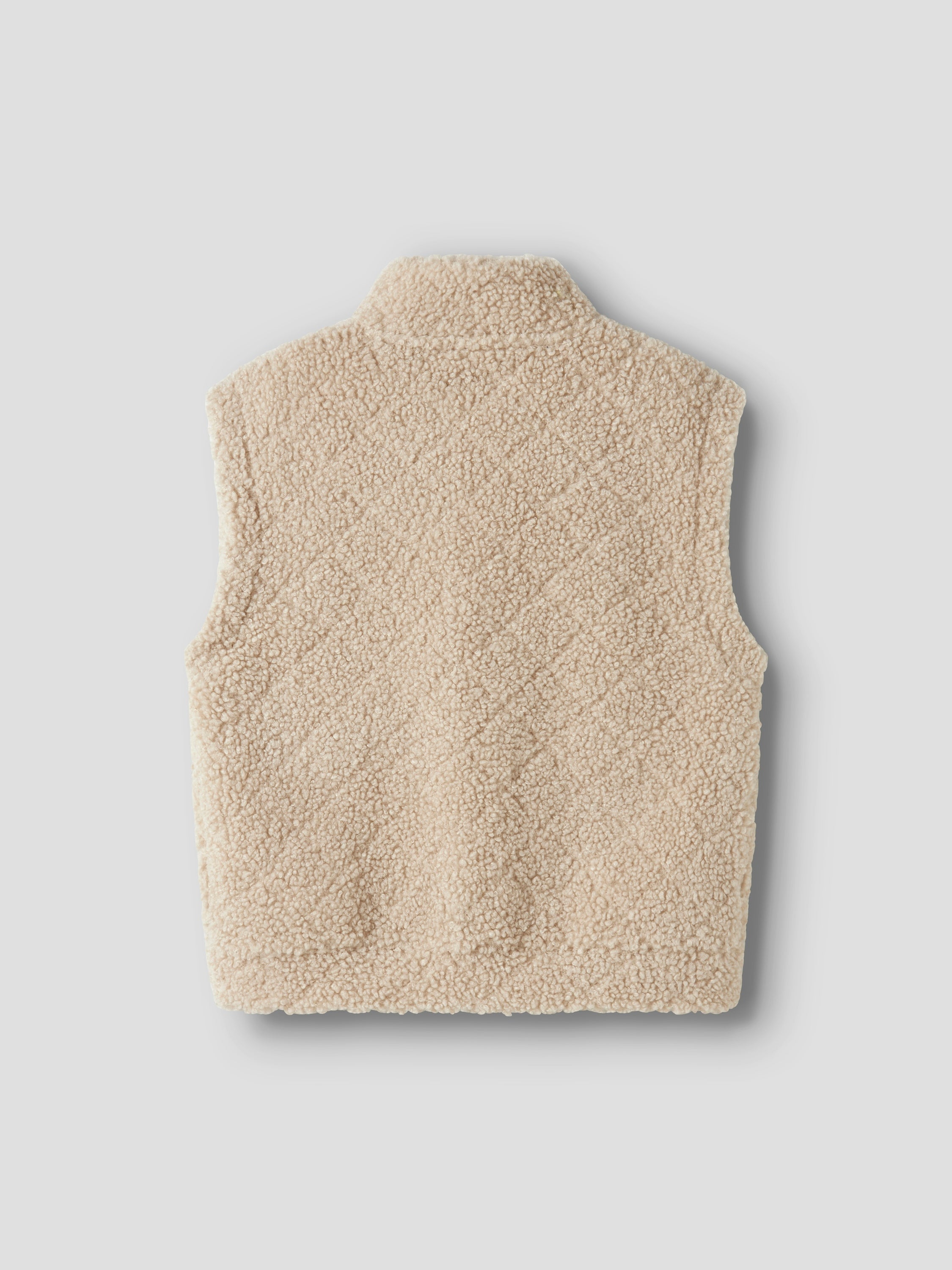 Beige bodywarmer in teddy stof met opgestikte zakken Name It